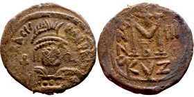 Heraclius (610-641) Follis. Obverse: Helmeted and cuirassed bust facing, holding globus cruciger and shield., Reverse: Large M above cross, ANNO

29...