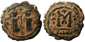 Umayyad Caliphate. temp. Mu'awiya I ibn Abi Sufyan (AH 41-60 / AD 661-680). Arab-Byzantine type, Hims.
AE Fals (20mm, 5,69g)
Obv: Two imperial figures...