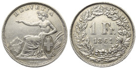 Schweiz. Eidgenossenschaft.

 1 Franken (Silber). 1861 B.
Vs: Sitzende Helvetia links.
Rs: Wert und Jahr in Kranz.

23 mm
. 4,98 g. 

HMZ 120...