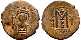 Maurice Tiberius (582-602) Follis. Obverse: Helmeted and cuirassed bust facing, holding globus cruciger and shield., Reverse: Large M above cross, ANN...