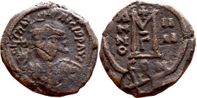 Maurice Tiberius (582-602) Follis. Obverse: Helmeted and cuirassed bust facing, holding globus cruciger and shield., Reverse: Large M above cross, ANN...