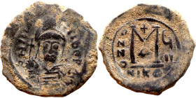 Maurice Tiberius (582-602) Follis. Obverse: Helmeted and cuirassed bust facing, holding globus cruciger and shield., Reverse: Large M above cross, ANN...