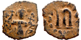Constans II (641-668) Follis. Obverse: Imperial figure holding cross and globus Reverse: m and inscription
