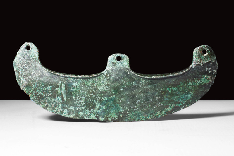 EGYPTIAN BRONZE AXE HEAD

Ca. 2045 - 1794 BC. A bronze, crescent-shaped axe he...