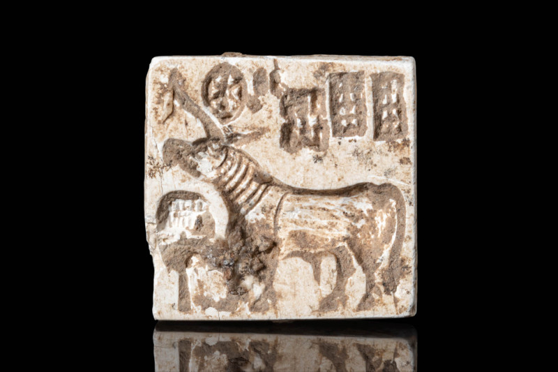 HARAPPAN STONE STAMP SEAL WITH BULL

ca. 2600 - 1900 BC. A carved cream stone ...