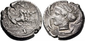 Syracuse. Tetradrachm signed by Euainetos circa 413-405, AR 17.18 g. Fast quadriga driven r. by charioteer holding reins and kentron. Above, Nike flyi...
