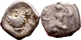 Lycaonia: Laranda (IV- III century BV) Obol. Obv:Baaltars seated left, holding grain ear, grape bunch, and scepter. Rev: Forepart of wolf right;