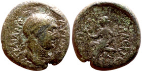 Hadrian (117-138) bronze coin. Obv: Bus of Emperor. Rev: Apollo seated left on omphalos, testing arrow and resting left hand on grounded bow