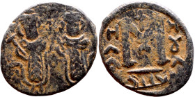 al-Malik ibn Marwan (687-705), Constans II style folis Obverse: Imperial figures holding globus Reverse: m and inscription