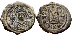 Maurice Tiberius (582-602) Follis. Obverse: Helmeted and cuirassed bust facing, holding globus cruciger and shield., Reverse: Large M above cross, ANN...