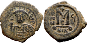 Maurice Tiberius (582-602) Follis. Obverse: Helmeted and cuirassed bust facing, holding globus cruciger and shield., Reverse: Large M above cross, ANN...