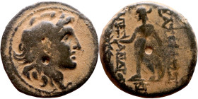 Alexander I Ballas (Seleukid king: 150-145) Bronze. Obv: Head of Alexander I right in lion skin headdress Rev: Apollo standing left, testing arrow and...