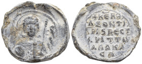 BYZANTINE LEAD SEAL. (6.3 Gr. 19mm.)
Nimbate facing bust of Saint George, holding spear over his right shoulder and shield on his left arm Rev: Legend...