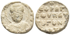 Byzantine Lead Seal, (15mm, 4.2 g) Nimbate facing bust of Saint. / Legends in four lines.