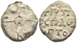 Byzantine Lead Seal, (20mm, 10,5 g) Cruciform monogram. / Legends in three lines.