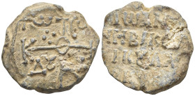 Byzantine Lead Seal, (22mm, 10,3 g) Cruciform monogram. / Legends in four lines.
