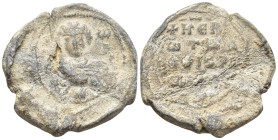 Byzantine Lead Seal, (22mm, 6.1 g) Nimbate facing bust of Saint George, holding spear over his right shoulder and shield on his left arm. / Legends in...