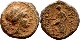 Seleukos II Kalinikos (Seleukid King: 246 - 226 BC) AE bronze. Obv: Diademed head of Seleucus II right Rev: Apollo seated left on omphalos, testing ar...