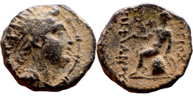 Antiochos IV (Seleukid King: 175-164 BC). AE bronze. Obv.: Radiate and diademed head right. Rev.: Apollo seated left on omphalos, testing arrow and re...