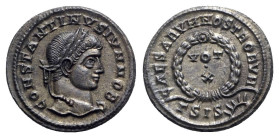 Constantine II (Caesar, 316-337). Æ Follis (19mm, 3.32g, 12h). Siscia, 321-4. Laureate head r. R/ VOT/ X in two lines within laurel wreath; ΓSIS-sunbu...