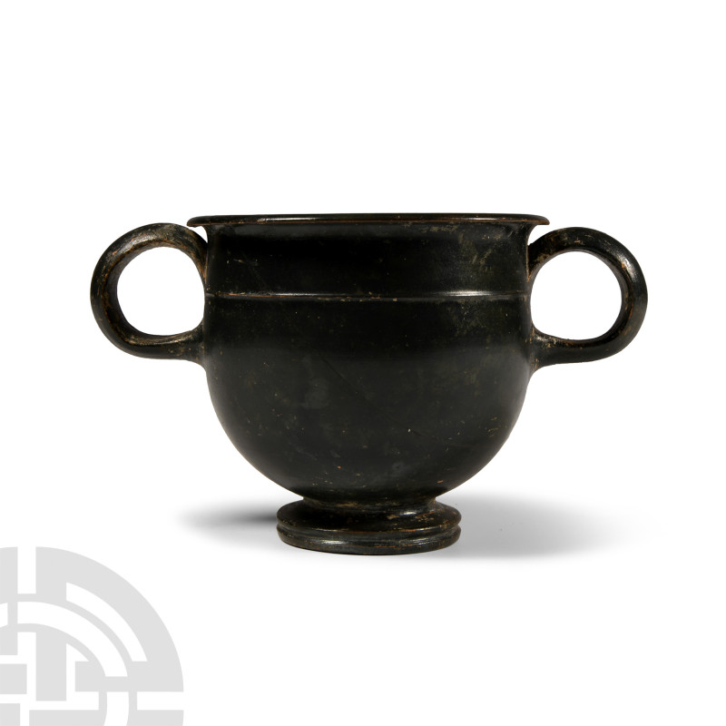 Greek Double-Handled Blackware Wine Cup

5th-3rd century B.C. High-glazed, the...