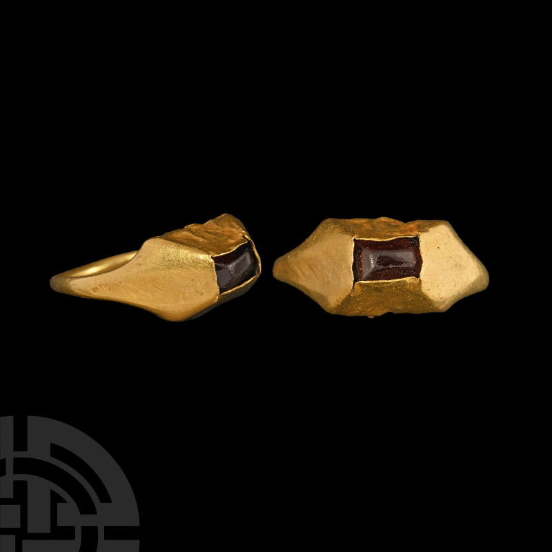 Medieval Gold Ring with Garnet Cabochon

13th-14th century A.D. With a slender...
