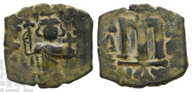Arab-Byzantine, Time of the Rashidun AE Fals. Circa AH 19-39 (AD 641-660). Uncertain mint. Pseudo-Byzantine type, imitating a follis of Constans II.