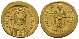 JUSTINIAN I (527-565). GOLD Solidus. Constantinople.
Obv: D N IVSTINIANVS P P AVG.
Helmeted and cuirassed bust facing, holding globus cruciger and shi...
