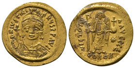 JUSTINIAN I (527-565). GOLD Solidus. Constantinople.
Obv: D N IVSTINIANVS P P AVG.
Helmeted and cuirassed bust facing, holding globus cruciger and shi...
