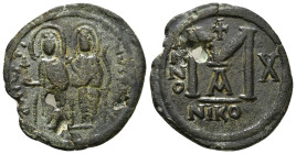JUSTIN II (565-578). Follis. Nicomedia.
Obv: D N IVSTINVS P P AVG.
Justin, holding globus cruciger, and Sophia, holding cruciform sceptre, seated faci...