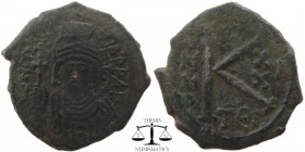 Maurice Tiberius AE Half follis Thessalonica 582-602 AD. DN MAVRC TIB PP AVG, helmeted and cuirassed or crowned and cuirassed bust facing, holding cro...