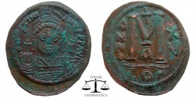 Justinian I AE Follis Constantinople 541/2 AD. DN IVSTINI-ANVS PP AVG, helmeted and cuirassed bust facing, holding cross on globe and shield with hors...