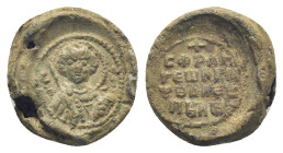 Byzantine Lead Seal, (16mm, 4.0 g) Nimbate bust of Saint George facing, holding spear over his right shoulder and resting shield on his left arm. / Le...