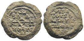 Byzantine Lead Seal, (29mm, 26.2 g) Cruciform monogram. / Legends in four lines.