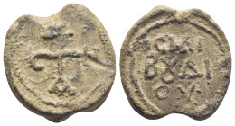 Byzantine Lead Seal, (23mm, 11.6 g) cruciform monogram;. / Legends in three lines.