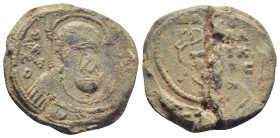 Byzantine Lead Seal, (24mm, 11.4 g) Nimbate military saint (Georgios?) bust facing, holding spear and shield. / Legends in three lines.