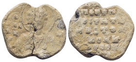 Byzantine Lead Seal, (26mm, 10.0 g) Bust of saint facing, nimbate, holding gospel./ Legends in five lines.