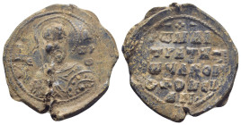 Byzantine Lead Seal, (28mm, 9.3 g) Nimbate military saint bust facing, holding spear and shield. / Legends in four lines.