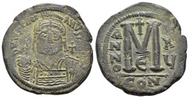 JUSTINIAN I.(527-565).Constantinople.Follis.
Obv : D N IVSTINIANVS P P AVC.
Helmeted, cuirassed bust facing, holding cross on globe and shield with ho...