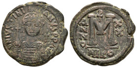Justinian I (527-565) AE Follis Nicomedia.
Obv: D N IVSTINIANVS P PAVG, Helmeted and cuirassed facing bust, holding globus cruciger and shield; cross ...