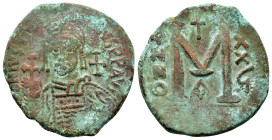 JUSTINIAN I (527-565).Antioch.Follis.
Obv : D N IVSTINIANVS P P A.
Helmeted and cuirassed bust facing, holding globus cruciger and shield; cross to ri...