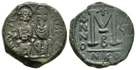 "Justin II. 565-578. Æ follis Nicomedia, 570-571. D N IVSTINVS P P AVG, Justin on left, Sophia on right, seated facing on double-throne, both nimbate,...