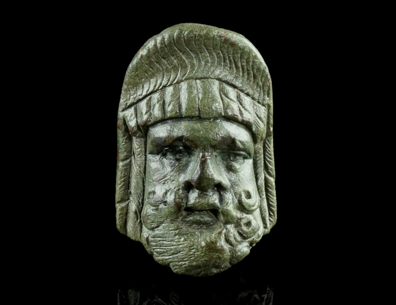 A ROMAN BRONZE THEATRE MASK APPLIQUE
Circa 1st-2nd century AD.
Well modelled app...