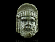 A ROMAN BRONZE THEATRE MASK APPLIQUE
Circa 1st-2nd century AD.
Well modelled applique in the form of a male tragic theatrical mask. The expressive fac...