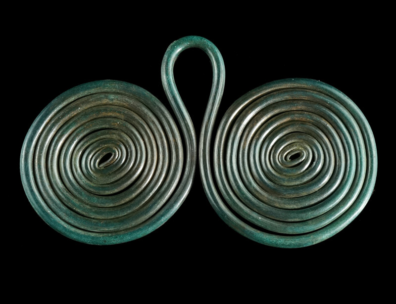 A EUROPEAN LATE BRONZE AGE DOUBLE SPIRAL PENDANT
Circa 1200-800 BC.
Composed of ...