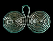 A EUROPEAN LATE BRONZE AGE DOUBLE SPIRAL PENDANT
Circa 1200-800 BC.
Composed of two coils of bronze rod connected by a suspension loop. With a magnifi...