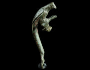 A ROMAN BRONZE JUG HANDLE IN THE SHAPE OF A PARROT
Circa 1st-2nd century AD.
Finely worked handle of a jug in the form of a perching parrot with long ...