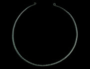 A EUROPEAN LATE BRONZE AGE TWISTED TORQUE
Circa 1000-800 BC.
Twisted hoop of solid bronze, the plain tapering ends with flattened coiled terminals. Be...