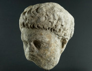 AN OVER LIFE-SIZED ROMAN MARBLE PORTRAIT HEAD
Circa 1st century AD.
Fragmentary marble head of a young, bearded man. Preserved is part of the front of...