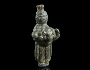 A ROMAN BRONZE STATUETTE OF PRIAPUS
Circa 2nd-3rd century AD.
The god of fertility is depicted wearing a modius and a long tunic, held up to contain a...